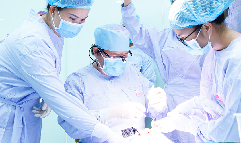 Doctor Vo Van Nhan is implementing dental implant using navigation system for a patient 
